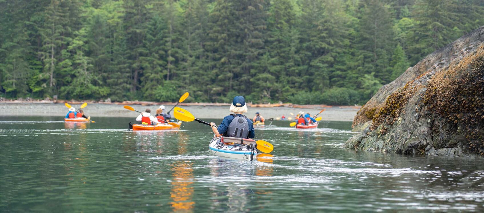 people kayaking down a river