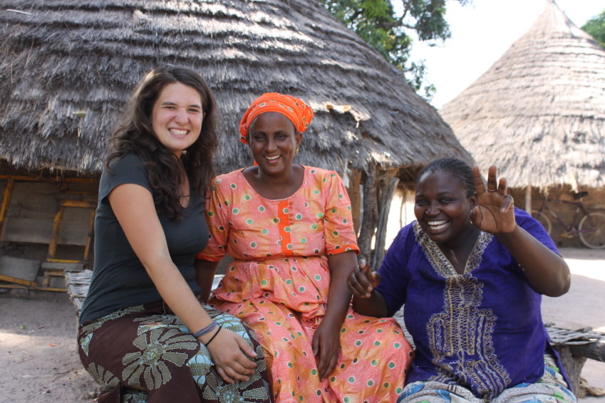 young woman studying abroad in west africa with two local woman