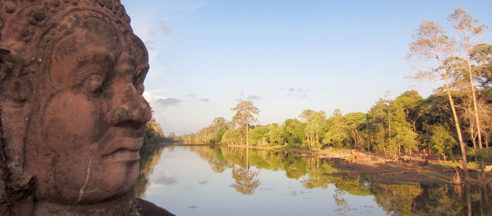 statue on the side of a river