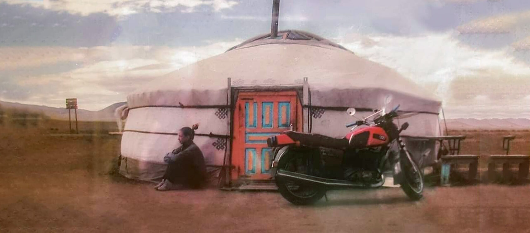 girl sitting next to Mongolian yurt