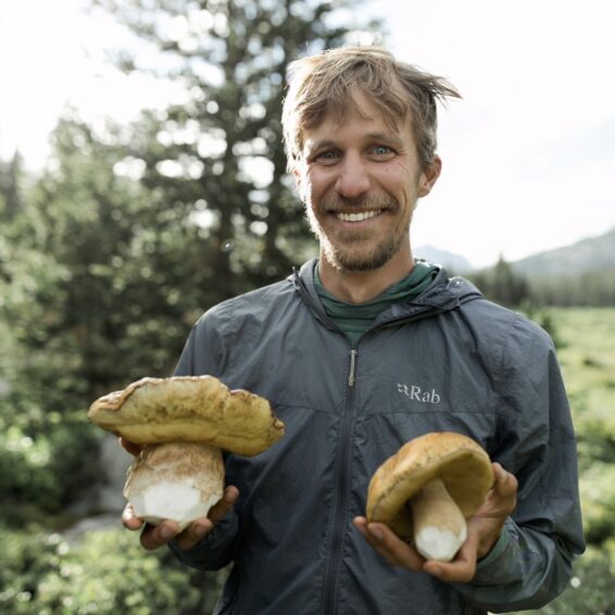 man holding big mushrooms