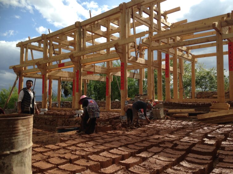 people building a house and bricks